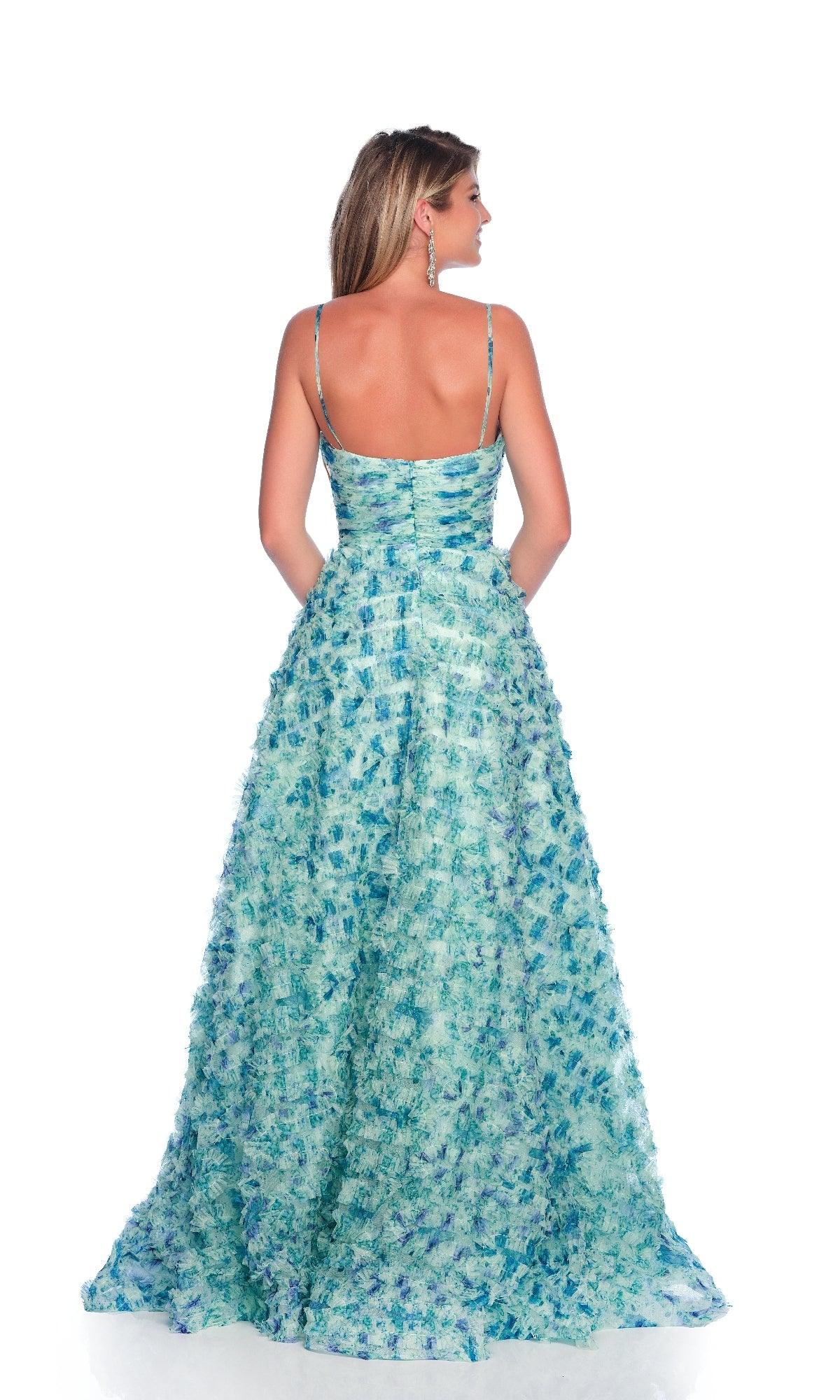 A woman faces away, wearing the Dave & Johnny 12094 Green Print Prom Ball Gown, featuring a fitted bodice, A-line skirt, thin straps, and elegant textured design against a plain white background.